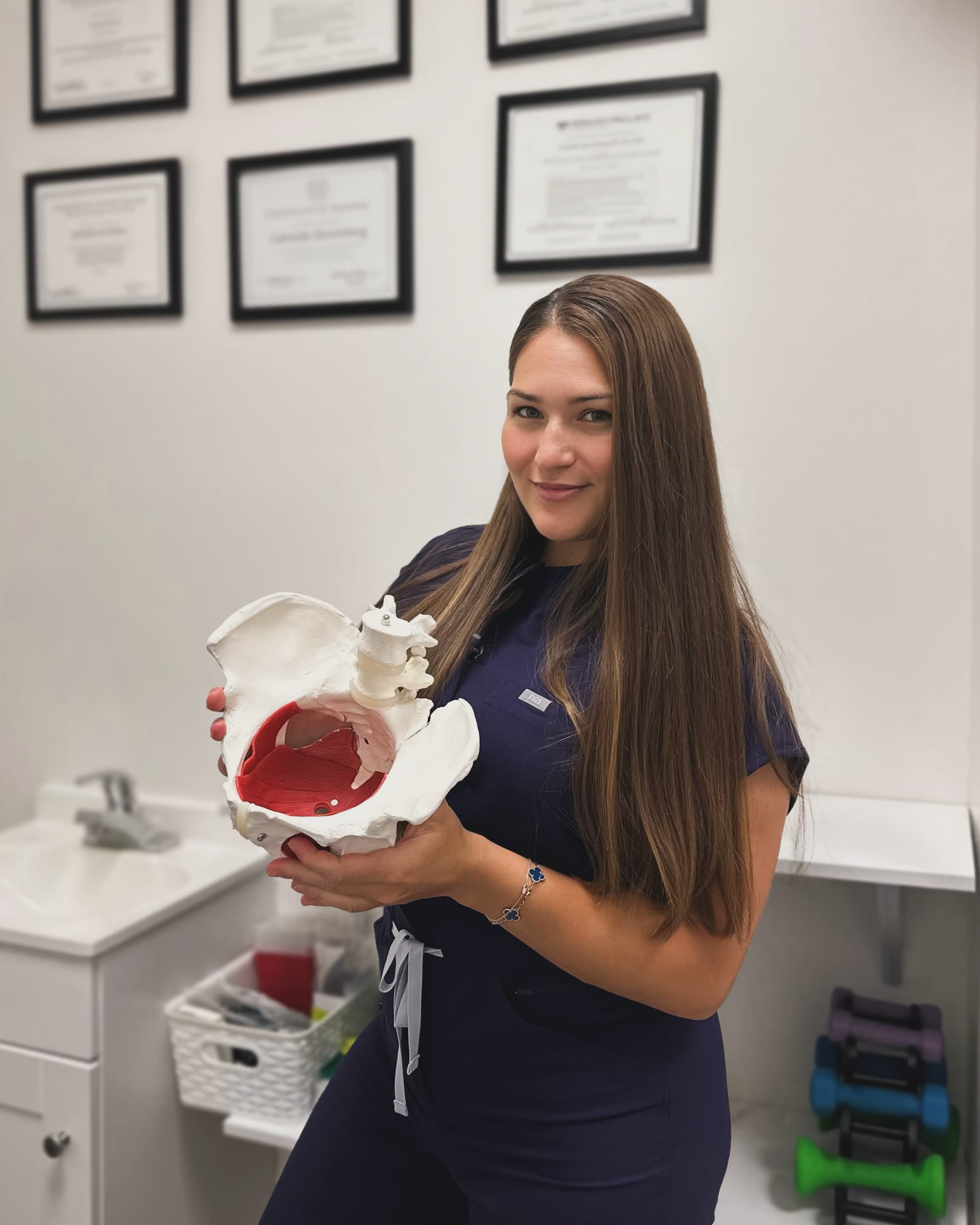 Dr. Gabriella Shvartsberg, PT, DPT, in her South Brooklyn clinic with her credentials displayed